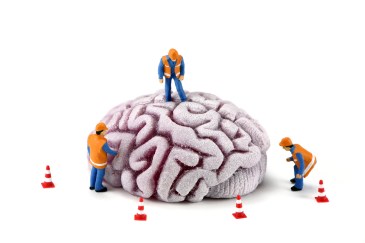 Brain with workers inspecting it. Mental Health concept